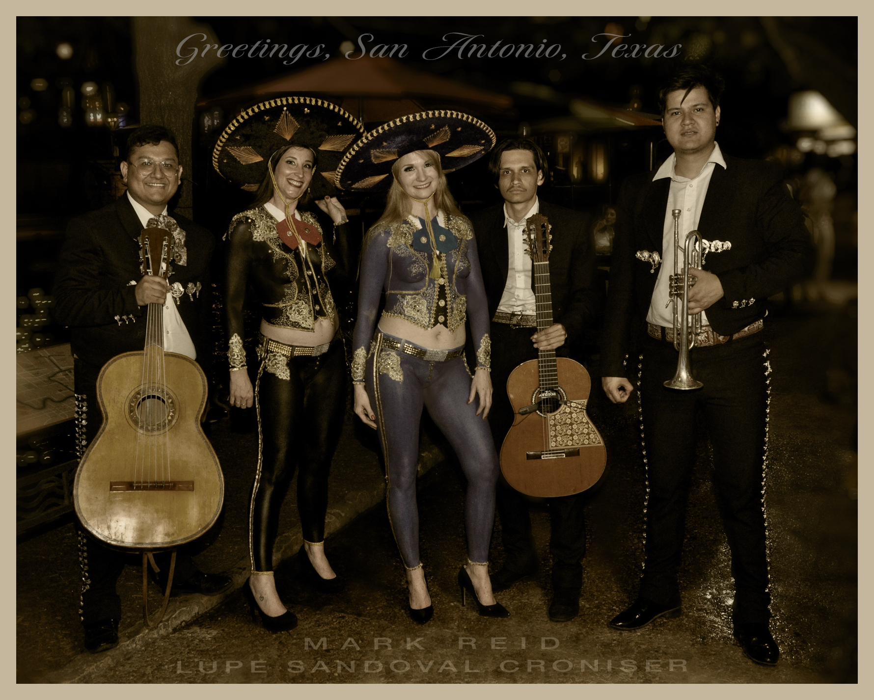 Sandy blonde woman wearing a full body painting that is black and gold and looks like the mariachi band that is in the picture with her